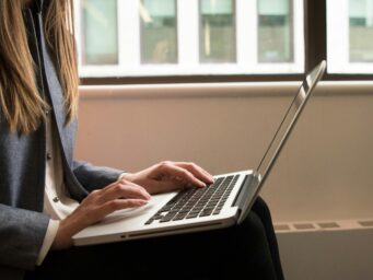 Woman working on a laptop, symbolizing freelance or full-time work.