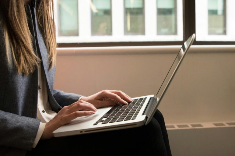 Woman working on a laptop, symbolizing freelance or full-time work.