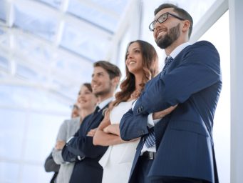 Diverse team of professionals looking forward, choosing an interim manager with Diktu